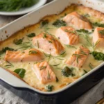 Creamy salmon casserole baked with pasta and cheese in a casserole dish.