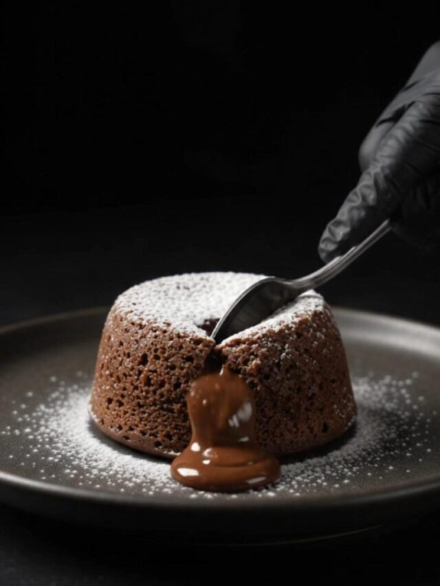 Chocolate lava cake with a rich, gooey chocolate center flowing onto a plate.
